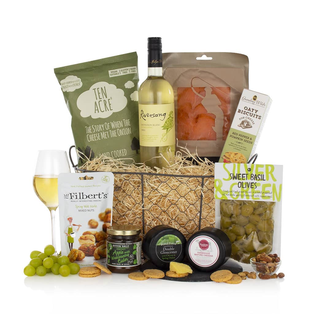 white wine, salmon, olives, and other snacks in a wire basket