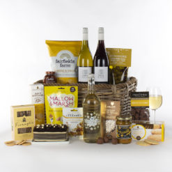 a grand gift basket with wine, sparkling drink, and snacks