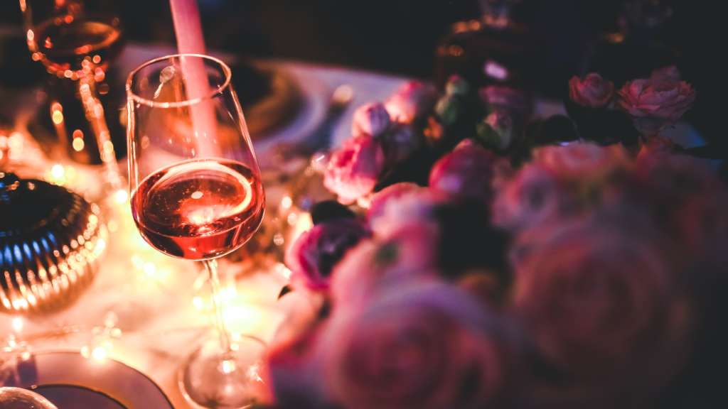 a table with wine and flowers
