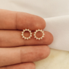 circle stud earrings outlined with cubic zirconia
