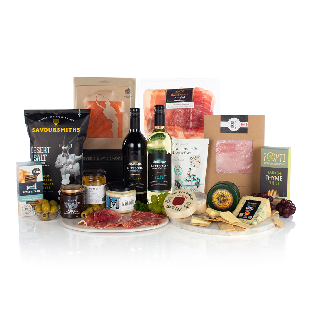 A luxurious gift basket with fresh food items, wine, cheese, and other snacks