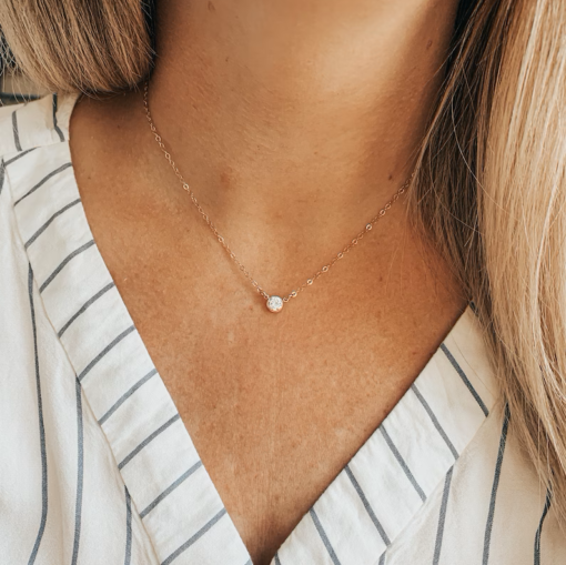 a silver necklace with crystal pendant