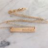 gold necklace with bar that states grandma