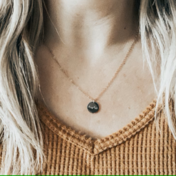 gold necklace with circle pendant that reads mama