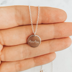 silver necklace with circle pendant that reads mama