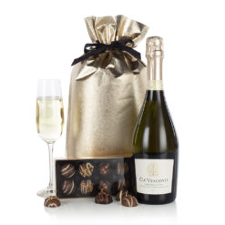 a bottle of champagne, a box of chocolates and a gold gift bag