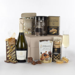 a bottle of champagne, crisps, shortbread, nut mix, chocolates, and cheddar bites